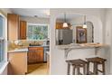 Well-lit kitchen with granite countertops, stainless steel appliances, and wooden cabinets at 30313 Arena Dr, Evergreen, CO 80439