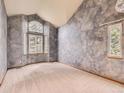 Large bedroom with unique gray textured walls, plush carpet, and large windows at 9412 La Quinta Way, Lone Tree, CO 80124