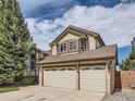 Attractive home with a three-car garage, siding, brick, and a driveway at 9412 La Quinta Way, Lone Tree, CO 80124