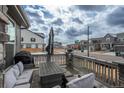 Outdoor patio with comfortable seating, a dining table, and an umbrella for shade, perfect for outdoor relaxation at 688 N Bersshine Ct, Watkins, CO 80137