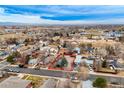 Highlighted property in aerial view, nestled among neighborhood homes with beautiful landscaping and mature trees at 329 2Nd St, Frederick, CO 80530