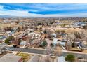 Expansive aerial view showcasing neighborhood homes and landscapes under a bright, partly cloudy sky at 329 2Nd St, Frederick, CO 80530