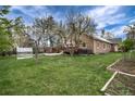 Spacious backyard with a hot tub, greenhouse, and a charming garden at 1970 Garland St, Lakewood, CO 80215
