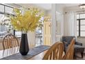 Bright dining area with yellow flowers and hardwood floors at 2643 S Cook St, Denver, CO 80210
