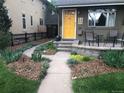 Landscaped front yard with walkway and patio at 2643 S Cook St, Denver, CO 80210