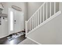 Welcoming entryway featuring dark floors, light walls, and staircase with white banister at 239 N Irvington St, Aurora, CO 80018