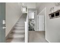 Bright entryway featuring stairs, neutral tones, and an open layout to the main living areas at 239 N Irvington St, Aurora, CO 80018