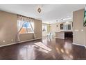 Open-concept living room boasts hardwood floors, lots of natural light, and seamlessly connects to the kitchen and dining areas at 21893 E Layton Dr, Aurora, CO 80015