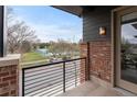 Balcony overlooking a tennis court and treed lawn at 188 S Locust St, Denver, CO 80224