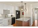 Well-lit kitchen featuring pendant lighting, granite counters, and stainless steel appliances at 7192 S Vine E Cir, Centennial, CO 80122