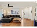 Inviting living room boasting hardwood floors, a cozy sectional, and ample natural light at 7192 S Vine E Cir, Centennial, CO 80122