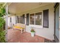 Inviting front porch features a charming bench and well-maintained landscaping near the home's entrance at 1935 Oneida St, Denver, CO 80220