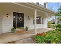 Inviting front porch with a beautiful front door and colorful flower arrangements at 6769 E Costilla Cir, Centennial, CO 80112