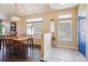 The dining room features hardwood floors, natural light, and a blue-painted front door at 1281 S Allison St, Lakewood, CO 80232