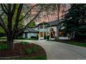 Elegant home featuring a circular driveway, classic brickwork, and well-manicured landscaping at 5345 S Race Ct, Greenwood Village, CO 80121