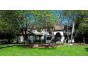 A home with a well-manicured front yard and large trees at 5345 S Race Ct, Greenwood Village, CO 80121