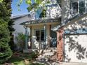 Inviting front entrance with a covered porch, brick accents, and well-kept landscaping at 1250 S Boyero Ct, Superior, CO 80027