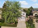 Two-story home with trees, well-maintained lawn, and a two-car garage at 1250 S Boyero Ct, Superior, CO 80027