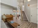 Open living room featuring beautiful wood floors, staircase, and ample natural light at 1250 S Boyero Ct, Superior, CO 80027