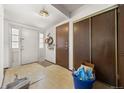 Bright entryway featuring neutral walls, tile flooring, closet space, and white front door at 2742 S Xanadu Way, Aurora, CO 80014