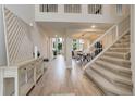 Inviting foyer with hardwood floors and staircase to the upper level and neutral decor at 14075 Turnberry Ct, Broomfield, CO 80023