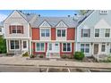 Inviting two-story townhome with colorful facade, landscaped front, and dedicated parking at 6776 S Independence St, Littleton, CO 80128