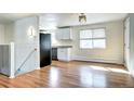 Modern kitchen with white cabinets, granite countertops, and stainless steel appliances at 7704 Newland St, Arvada, CO 80003