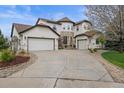 Beautiful stucco house with three-car garage, circular drive and stone accents at 22485 Laurel Oak Dr, Parker, CO 80138