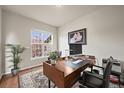 Home office with a large window, hardwood floors, desk and stylish decor at 22485 Laurel Oak Dr, Parker, CO 80138