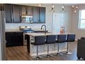 Modern kitchen features stainless steel appliances, granite countertops and a center island at 4680 Copeland Loop # 203, Highlands Ranch, CO 80126