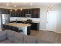 Eat-in kitchen boasts stainless steel appliances, dark cabinets, and a center island with barstool seating at 4680 Copeland Loop # 203, Highlands Ranch, CO 80126
