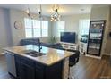 Open concept living room, with a kitchen island, providing ample space for entertaining guests at 4680 Copeland Loop # 203, Highlands Ranch, CO 80126