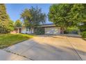 Spacious two-car garage and driveway, perfect for multiple vehicles and easy access at 5857 S Logan Ct, Centennial, CO 80121