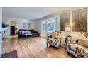 Bright living room featuring hardwood floors, bay window, and stylish decor at 5857 S Logan Ct, Centennial, CO 80121