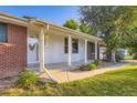 Inviting front porch with classic columns and a well-maintained garden in front at 5857 S Logan Ct, Centennial, CO 80121