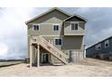 Back exterior view of a two-story home featuring a wooden deck with stairs leading down to a concrete basement at 16858 Greyhawk Dr, Monument, CO 80132