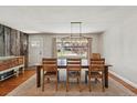 Light-filled dining room featuring wood floors, decorative lighting and a large window with a view at 13905 W 21St Ave, Golden, CO 80401