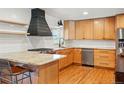Modern kitchen boasting stainless steel appliances, a granite countertop, and custom cabinetry at 13905 W 21St Ave, Golden, CO 80401