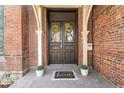 Inviting front entrance with double doors, decorative wreaths, and a 'home' welcome mat at 2318 Arapahoe St, Denver, CO 80205