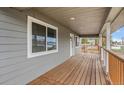 Covered porch featuring rich wood and gray trim which provides an ideal spot for relaxation at 400 Division Blvd, Platteville, CO 80651