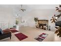 Inviting living room with a stone fireplace, vaulted ceilings, and lots of natural light at 977 S Salida St, Aurora, CO 80017