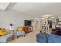 Inviting living room featuring an open layout, light wood floors, and stylish contemporary furnishings at 800 N Washington St # 307, Denver, CO 80203
