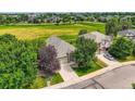 Aerial view of a single-Gathering home showcasing its mature landscaping and proximity to community green space at 12164 Adams St, Thornton, CO 80241