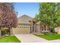 Charming stone-clad home with a well-manicured lawn and an attached two-car garage at 12164 Adams St, Thornton, CO 80241
