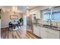 Modern kitchen with stainless steel appliances and adjacent dining area at 6914 E Briarwood Dr, Centennial, CO 80112