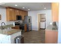 Well-lit kitchen with stainless steel appliances, granite countertops, and wood cabinets at 5068 Ensenada St, Denver, CO 80249