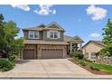 Inviting two-story home with a three-car garage, manicured lawn, and charming landscaping at 1575 Ridgetrail Ct, Castle Rock, CO 80104