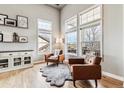 Bright living room featuring hardwood floors, many large windows, and comfortable leather chairs at 1575 Ridgetrail Ct, Castle Rock, CO 80104