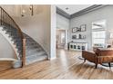 Bright living room with high ceilings, hardwood floors, and elegant staircase at 1575 Ridgetrail Ct, Castle Rock, CO 80104