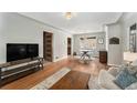 Inviting living room with hardwood floors, stylish furnishings, and open layout to the dining area at 1534 Rosemary St, Denver, CO 80220